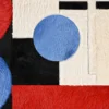 Luxury custom designer rug in red, blue, black, and white with abstract geometric shapes and soft, fur-like handmade hide textures.