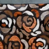 Close-up of a luxury designer rug, Procession Hide 15911, with abstract floral pattern in brown, black, white, and orange tones.