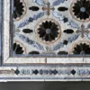 Close-up of luxury designer Aubusson Hide 15998 high-end handmade hide rug, featuring blue, black, beige, and white geometric and floral patterns.