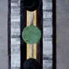 High end designer rug featuring three large circles on a striped luxury wool background.