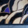 Close-up of Bloom Hide 15106 designer rug, handmade luxury hide with abstract tones on concrete.
