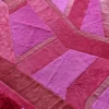 Vertigo Hide 15520 is a luxury designer rug with geometric fur-like panels in artisan pink and red.