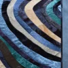Drift Hide 29332 luxury designer rug features curved multicolored stripes on a textured gray high-end area rug background.
