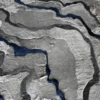 Close-up of Submerge Hide 27443, a luxury handmade designer rug with layered gray and blue textures in a wavy, abstract pattern.