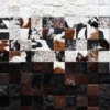 Luxury designer rug featuring a patchwork of handmade hide squares in a gradient pattern.