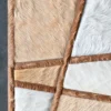 Close-up of Silhouette Hide 14495 designer rug, a luxury handmade hide rug with geometric brown and white pattern.