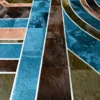 Close-up of a luxury custom handmade hide rug, showcasing geometric design and rich textures.