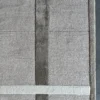 Close-up of a luxury designer wool and silk area rug, handmade with high-end geometric pattern.