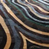 Close-up of Drift Hide 29332 luxury designer rug with wavy, layered textures in premium handmade hide.