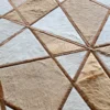 Close-up of a luxury designer rug with beige and brown fur-like geometric pattern, ideal for high end interiors.