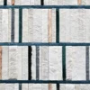 Close-up of luxury designer rug with vertical textured fur strips in neutral tones, divided by thin blue lines.