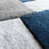 Close-up of Forms Wool 15486 luxury designer rug, handmade wool with blue and gray geometric textures.