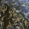 Close-up of Boulle Hide 29148, a luxury designer rug with ornate gold and brown floral texture.
