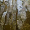 The Submerge Hide 25491 is a high end designer handmade hide rug in brown, beige, and gray patchwork.
