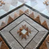 Luxury designer rug featuring a geometric pattern of diamonds and triangles in hand-crafted hide.