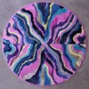 Luxury handmade designer rug with wavy multicolored bands in a circular high-end textile pattern.