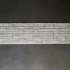 Beltway Hide 25131: luxury designer handmade hide rug with white stone tile pattern on dark gray.