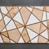 Luxury designer rectangular rug with tan, brown, and white geometric hide pattern.