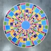 Luxury custom designer rug featuring colorful concentric geometric shapes on gray concrete.