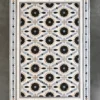 Aubusson Hide 15998 luxury designer rug featuring floral and geometric motifs in high end handmade hide and wool on a gray floor.