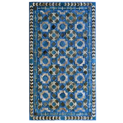 This high end designer rug showcases a blue, beige, and brown geometric floral pattern with diamond and zigzag borders.