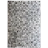A rectangular surface of high end designer rugs with small, textured gray tiles in a grid.