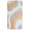 Luxury designer rug with wavy beige, tan, and white patterns on a high-end rectangular surface.