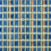 Luxury designer rug with a geometric plaid pattern in blue, green, beige, and orange.