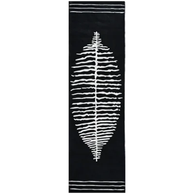 Luxury designer rug in black wool with a central white leaf and bold accent stripes.