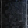 Luxury designer hide rug panel with glossy black checker design and stitched X accents.