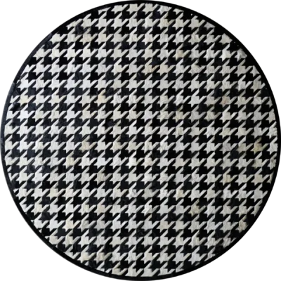 Luxury designer round rug in black and white houndstooth, handmade hide style.