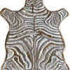 Luxury handmade hide rug featuring tanned zebra skin with bold white and brown stripes.