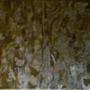 Submerge Hide 25491 is a luxury designer hide rug with wavy brown and gold patterns.