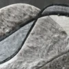 Close-up of luxury designer rug with gray faux fur patches and dark lines from Custom Hide 29456 collection.