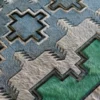 Close-up of high end designer rug Custom Hide 26748 with textured motifs in luxury handmade hide and wool.