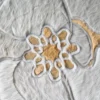Close-up of high-end handmade hide rug with luxurious white and tan floral pattern from Sweet Hide designer collection.