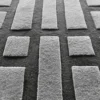 Tower Wool 15486 luxury handmade wool designer rugs in a grid on dark carpeting.