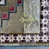Close-up of Winterlude Hide 26020, a luxury handmade designer rug with geometric patterns and textured accents.