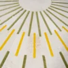 Shadowplay Hide 26287 is a luxury designer round rug with green and yellow sunburst lines on premium white hide.