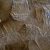 Portal Hide 25165 is a luxury designer rug with handmade hide patchwork in curved brown shapes.