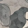 Luxury designer rug featuring abstract overlapping shapes in gray, beige, and black with textured patterns and dark outlines.