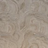 Close-up of this luxury designer rug’s textured beige surface with wavy, layered patterns reminiscent of high-end handmade hide rugs.