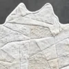 The Broken Hide 15788 is a luxury designer patchwork hide rug with faux fur, displayed on a dark grey floor.