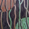 Luxury designer rug with abstract branch-like lines, orange and green circles on dark.