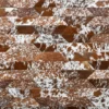Luxury designer rug with brown and white cowhide hexagons in a repeating geometric mosaic.