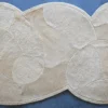 Luxury designer rug in beige with abstract ovals, handmade from Custom Hide 12580, shown on blue.