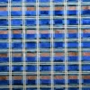 A luxury designer rug with a blue, brown, and gray plaid grid in high end handmade wool.