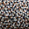 Close-up of the Leigh Hide 27210 high end designer rug with puffy hexagonal patches.