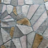 Luxury designer rug with geometric mosaic panels in gray, beige, gold and a fur-like hide texture.