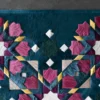 Kasbah Hide 15910 luxury designer rug with geometric pattern in vibrant shades, shown on gray.